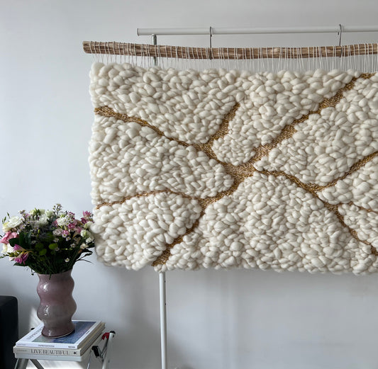 Thick wool relief with shimmering gold threads imitating kintsugi cracks