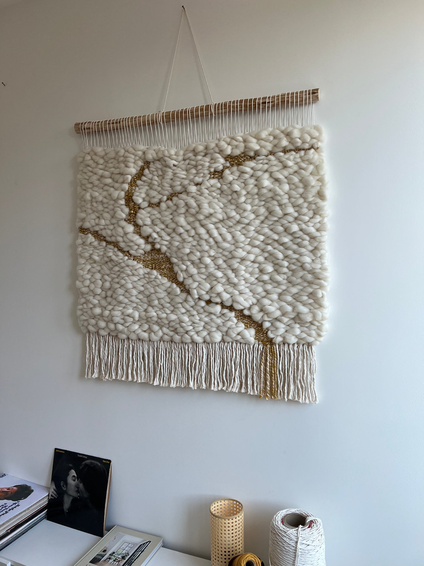 Angled side shot of textile wall art highlighting textured woven pattern