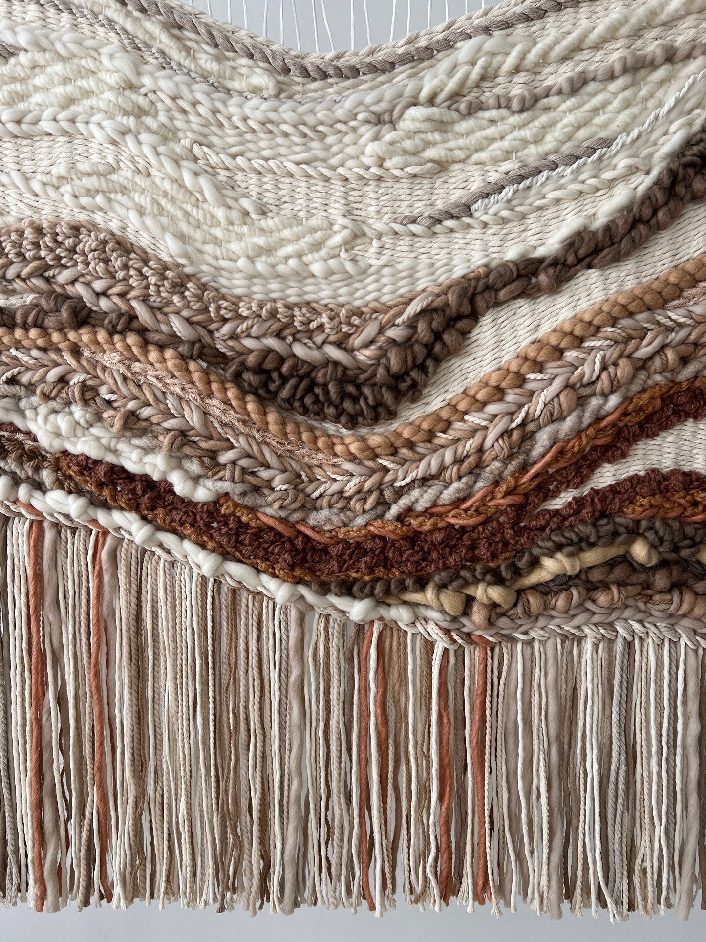 Close-up of cotton and wool blend showing texture variations – focus on earthy material contrasts