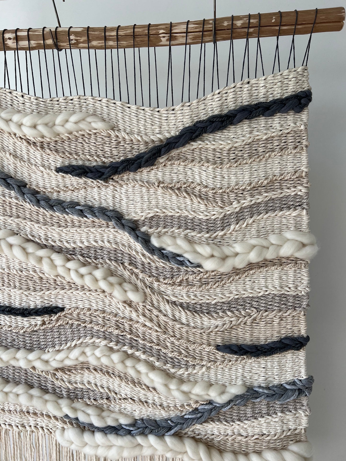 Textural details of the woven tapestry with organic flowing lines