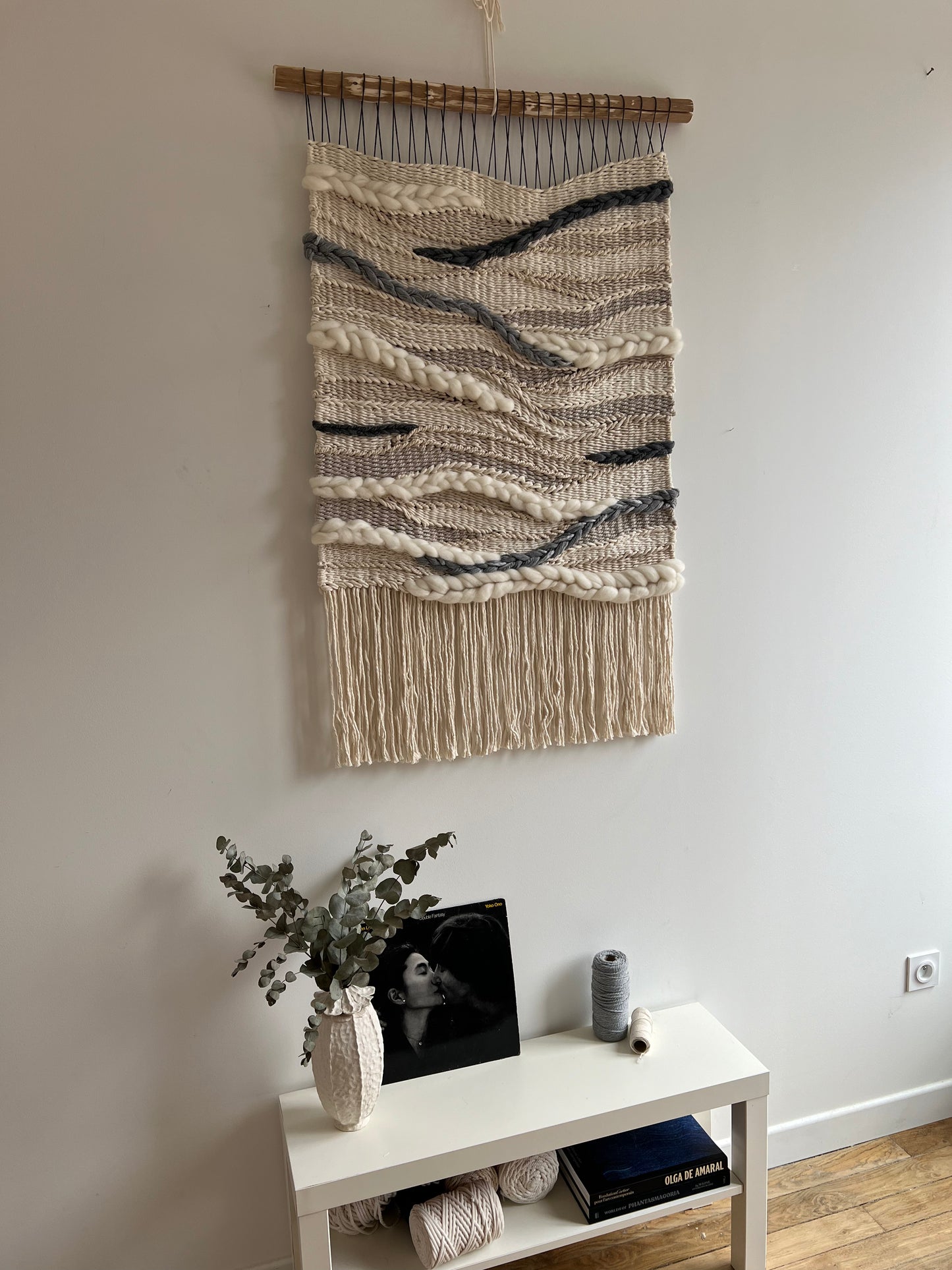 Side angle of the modern woven wall hanging showing its depth and texture