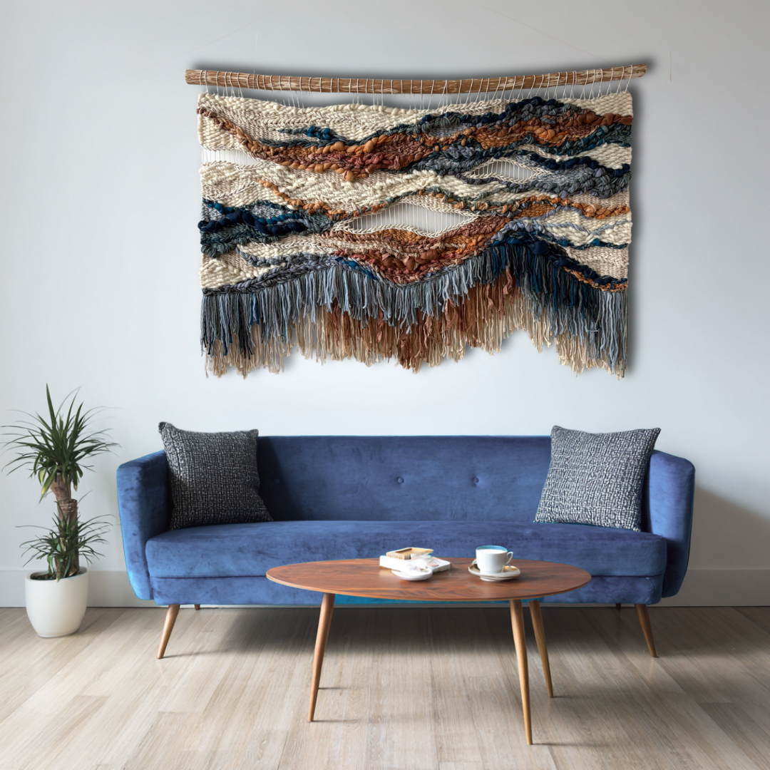 Terracotta and blue fiber art wall hanging styled above sofa in a contemporary living room