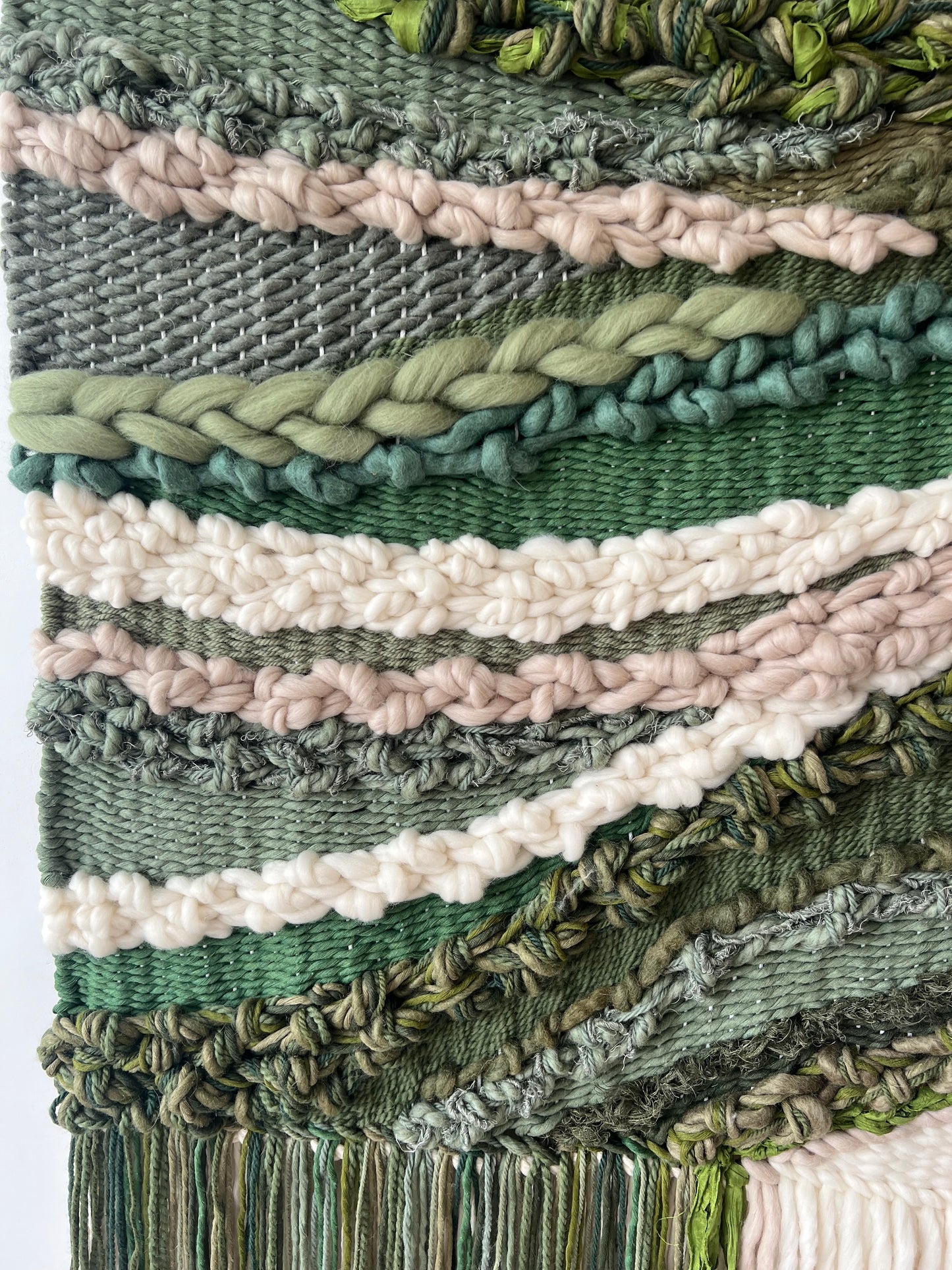 Detail of organic weaving patterns with mixed fibers in green and natural earthy shades