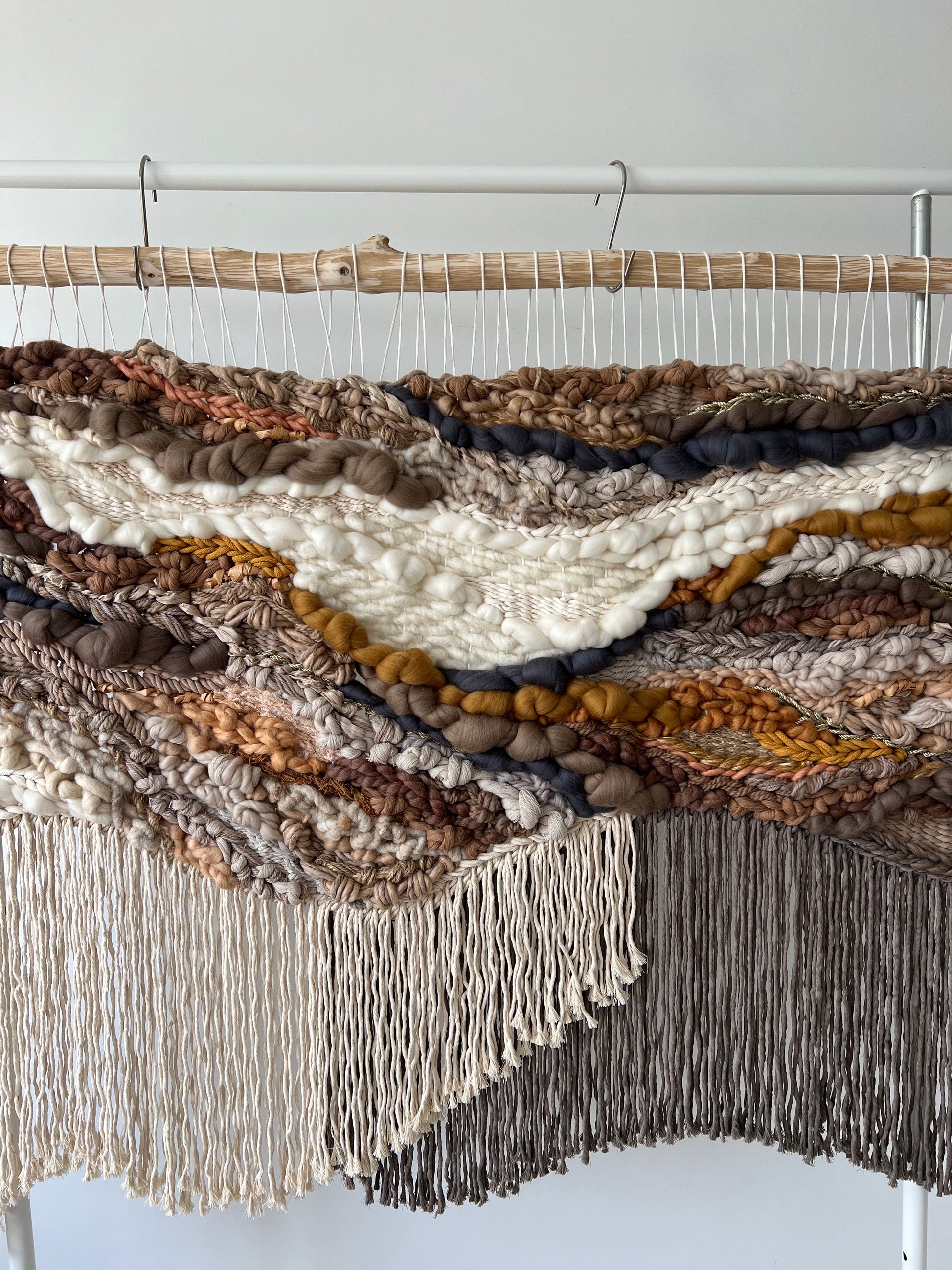 Close-up of handmade tapestry texture in natural earthy colors