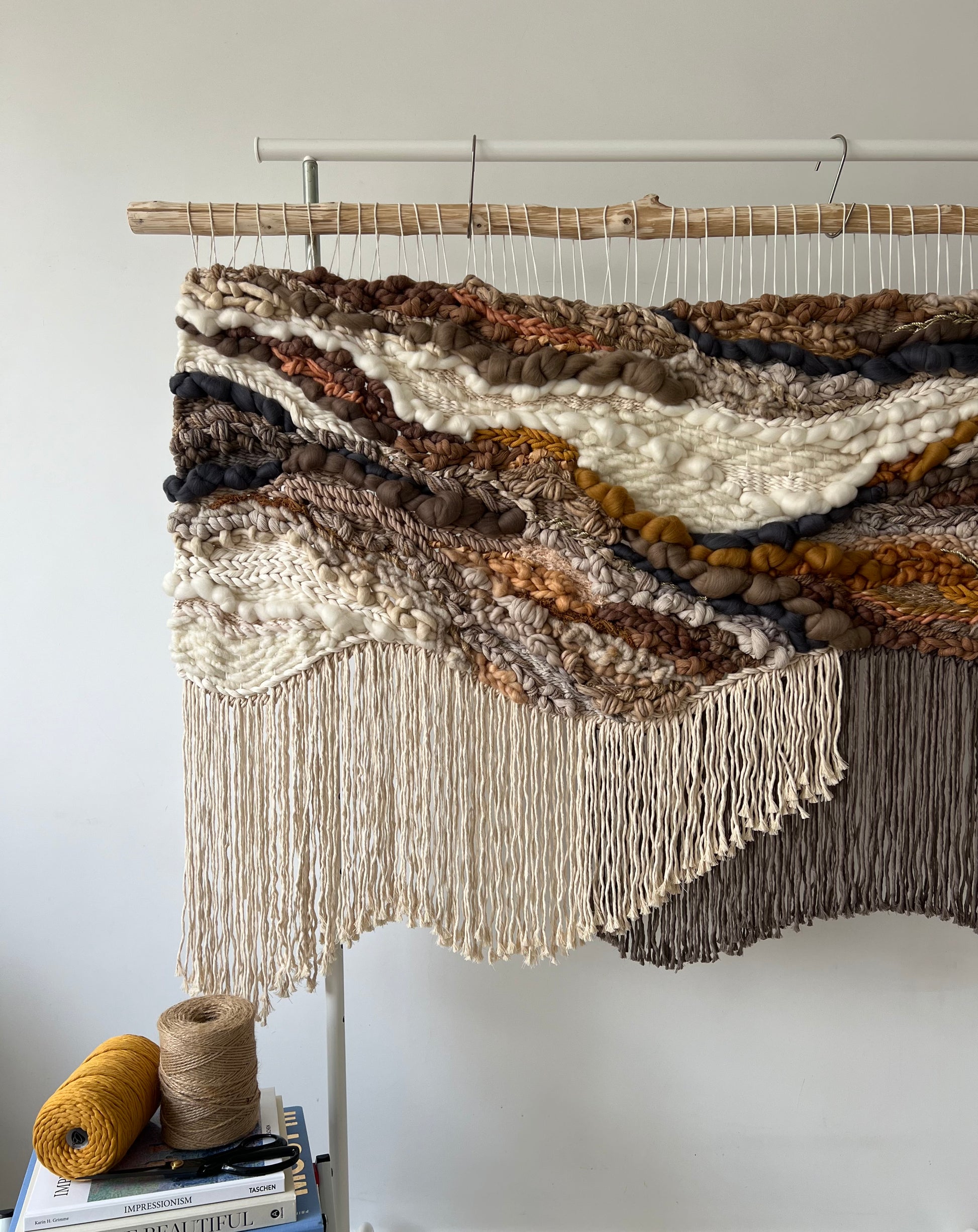 Natural fiber tapestry with warm earthy color palette