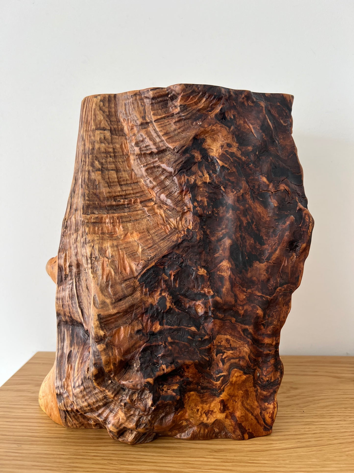 Close-up view of wooden lamp base made from solid ash, showing distinctive grain and handcrafted finish