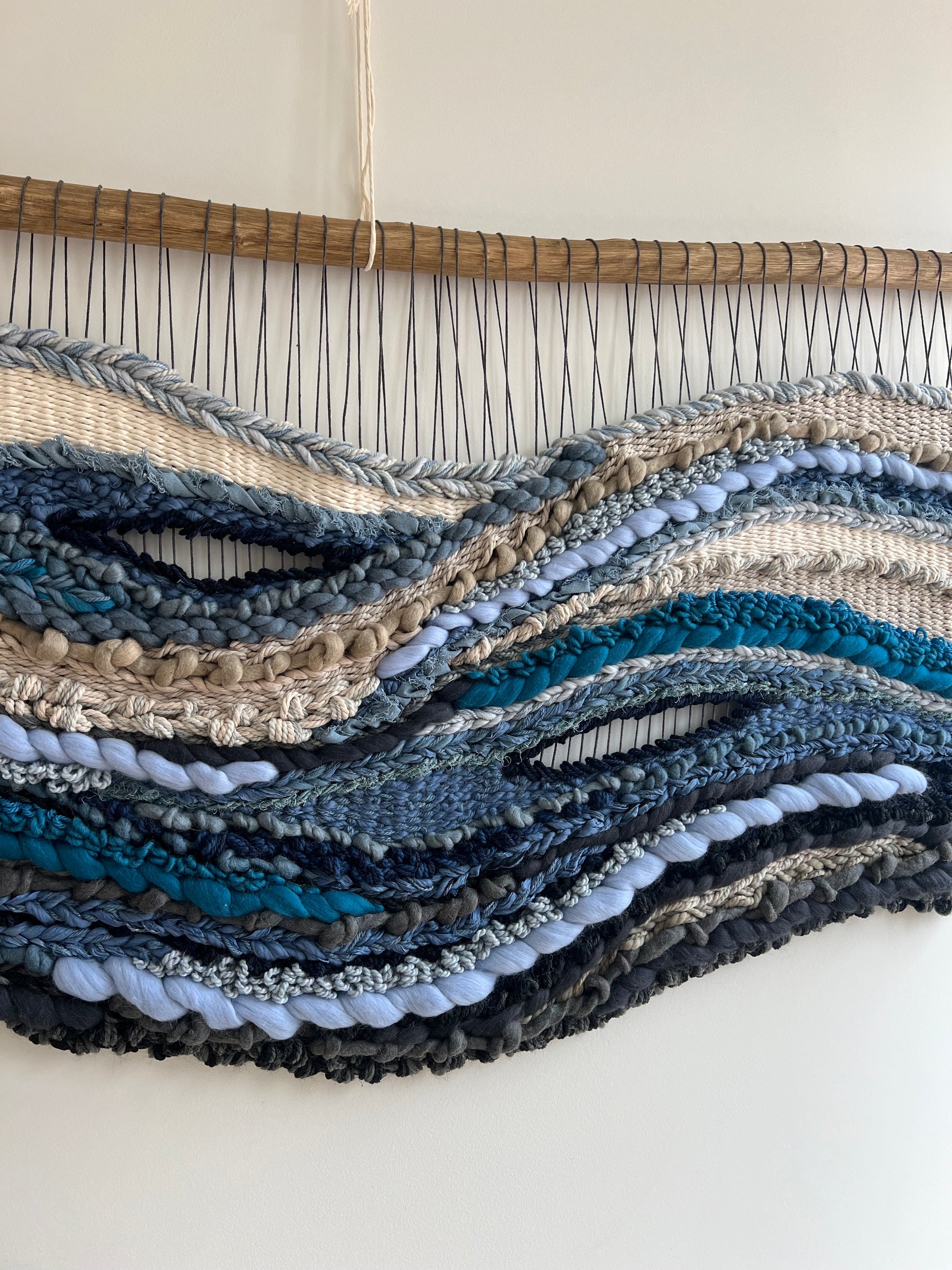 Macro detail of tapestry 'Breath of the Ocean', highlighting soft fiber layers in ocean-inspired tones