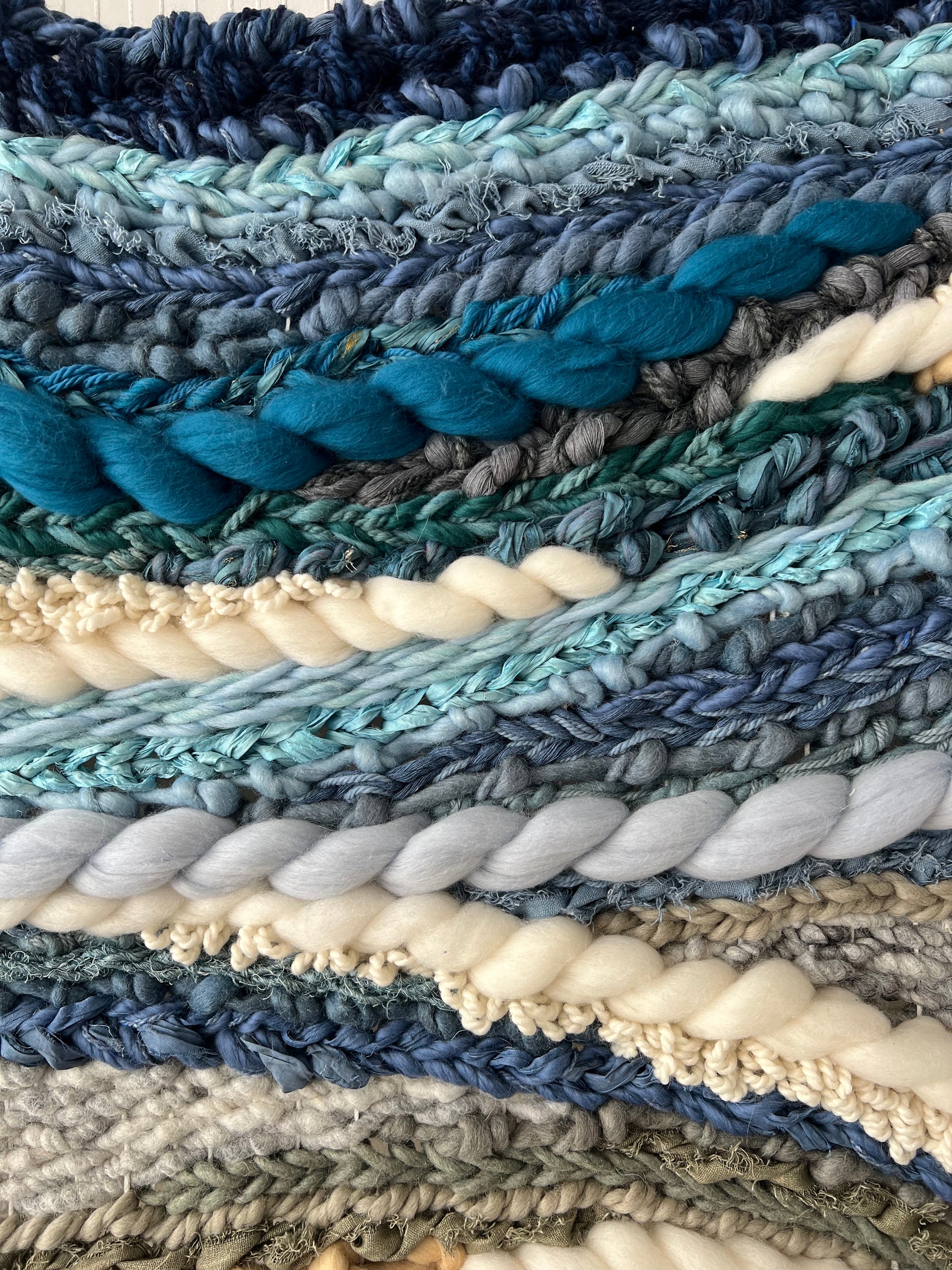 Detailed weave pattern of Glacier Drift wall art with layered blue threads